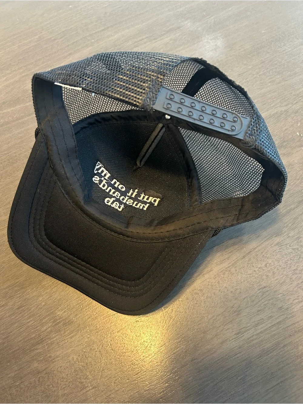 Black Trucker Cap with 'put it on my husband's tab' Embroidery